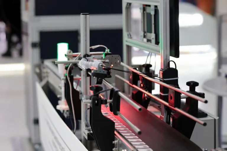 Optical sensors scanning coded parts on a conveyor line, among the factory sensing solutions used for inline verification