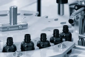 Dark bottles moving through an automated pharmaceutical filling line, the light-blocking packaging behind measuring opacity in plastic containers.